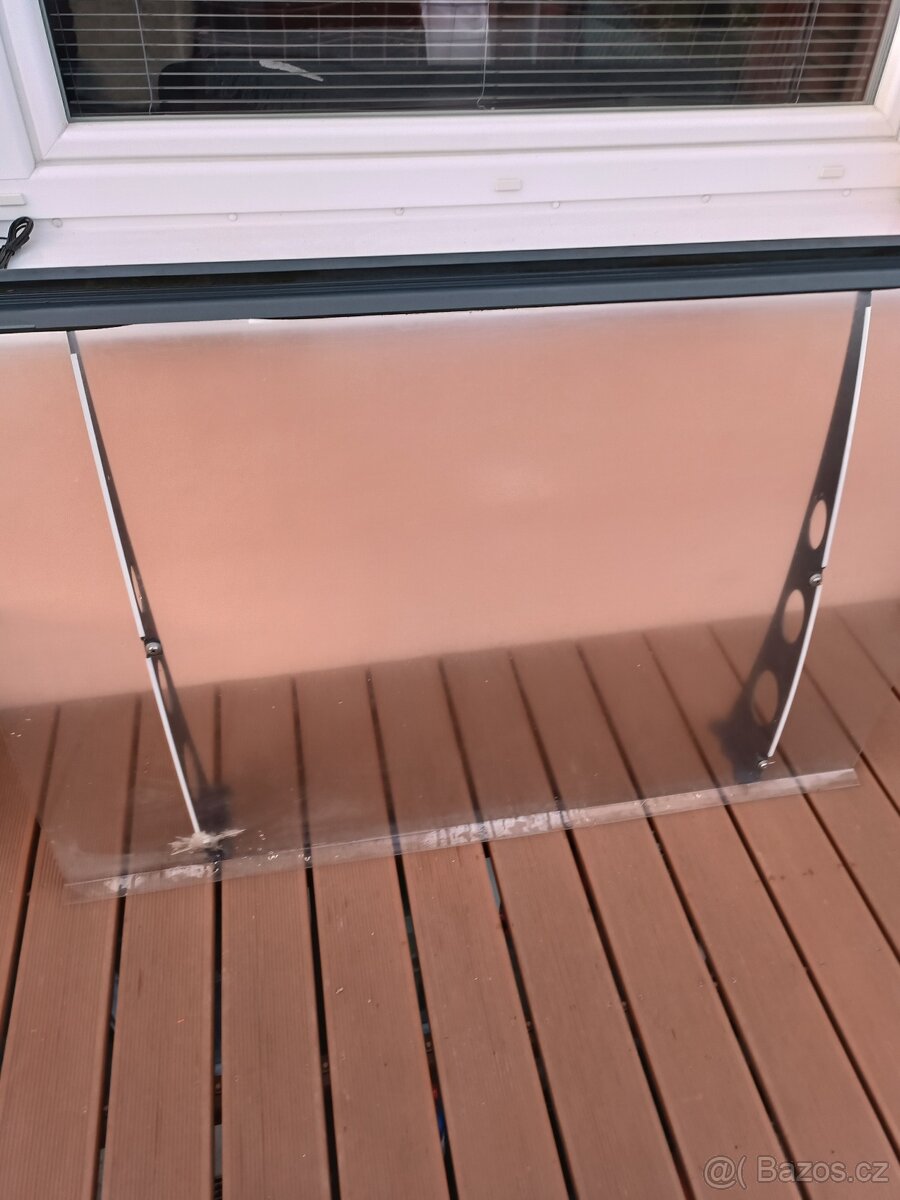 Průhledná stříška z plexiskla o rozměrech 135 x 95 cm.