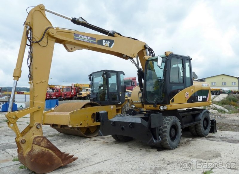 CATERPILLAR M313D - kolové rýpadlo,