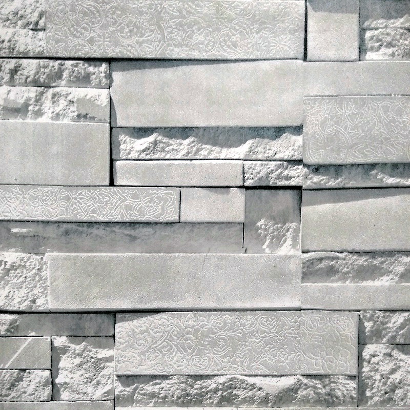 Tapeta vzor Světlý kamenný obklad s dekorativními rytinami