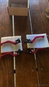 Držák na mobil,závažíčka do řídítek ,páčky - 10