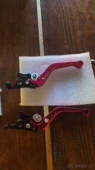 Držák na mobil,závažíčka do řídítek ,páčky - 15