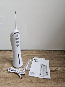 PRODÁM MÁLO POUŽITOU ÚSTNÍ SPRCHU OPTISMILE V ZÁRUCE - 1