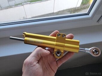 Prodám nový tlumič řízení na motorku s logem Ohlins
