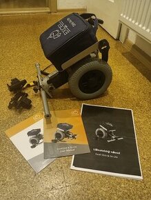 Přídavný motor k invalidnímu vozíku