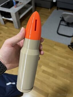 pokladnička ve tvaru náboje
