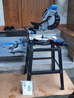 Prodám VĚTŠÍ NEPOUŽITOU pokosovou pilu s posuvem GÜDE GRK 25