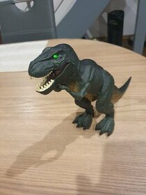 Dinosaurus - svítí , pochoduje a vydává zvuky.