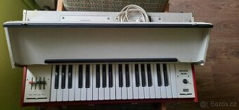 Retro elektrické varhany se stojánkem.