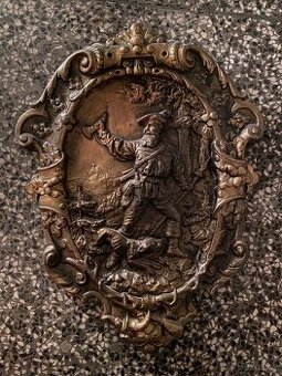 Kovový obraz myslivce se psem