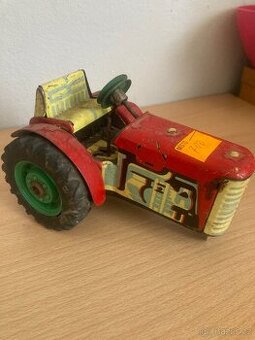Starý plechový traktor na klíček