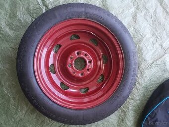 Dojezdové kolo Michelin 15 s přenosným vakem.