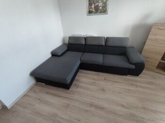 Rohová rozkládací sedací souprava.