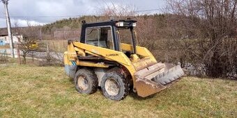 Smykový nakladač CATERPILLAR
