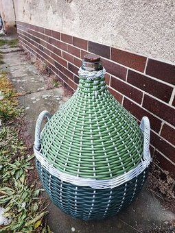 Nový velký demižon v plastovém koši.