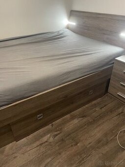 postel, rošt a matrace, noční stolek