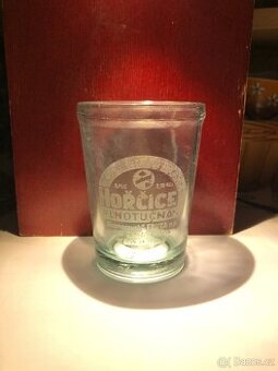 Stará sklenice hořčice a lžička Jednota, reklamní