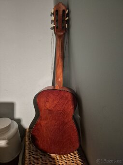 Venuji poskozenou kytaru