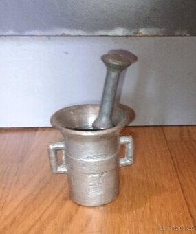 Starý litinový hmoždíř s paličkou