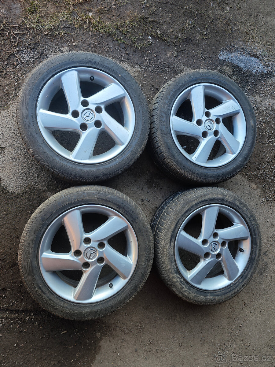Prodám sadu Alu disků Mazda 7Jx16H2 ET55 + pneu 205/55/16 - 2