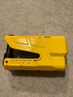 Zámek na brzdový kotouč, s řetězem. Abus - 2