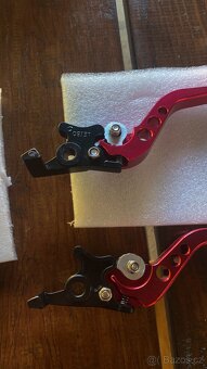 Držák na mobil,závažíčka do řídítek ,páčky - 9